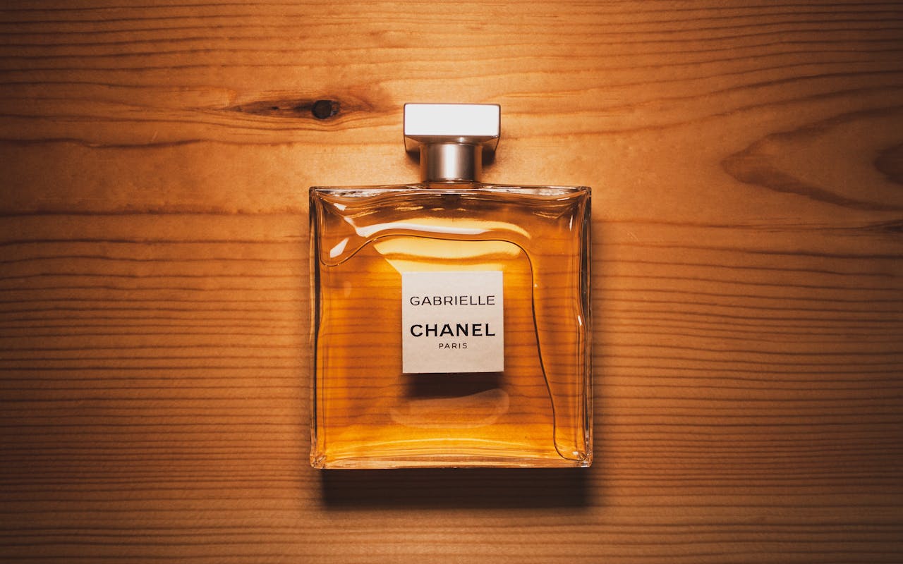 The Art of Drawing Readers In: Your attractive post title goes here Elegant Chanel perfume bottle displayed on a warm wooden surface, showcasing luxury and style.